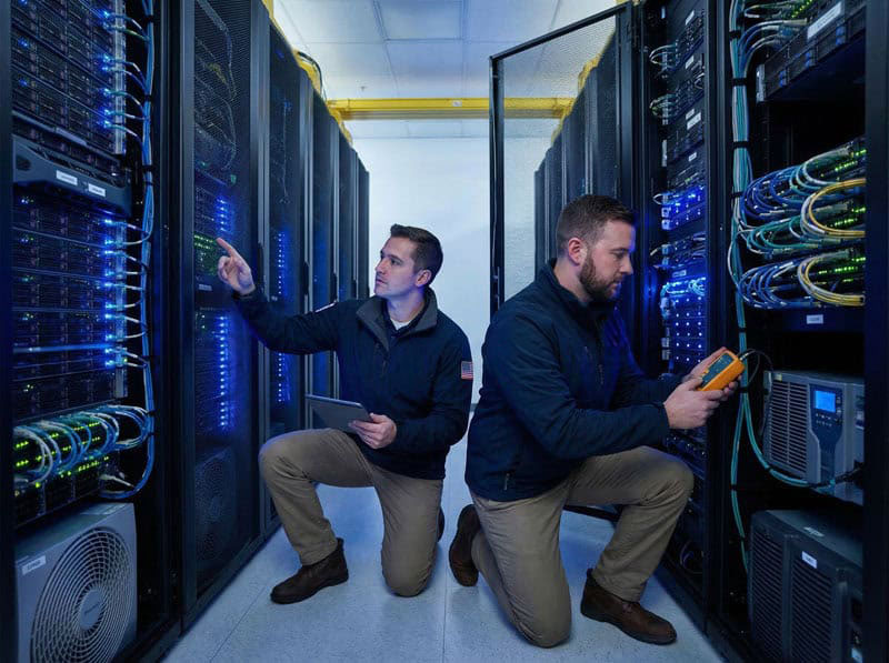 IT technicians inspecting server racks in a data center